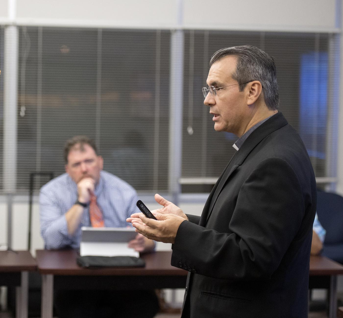 Father Rafael Ramirez teaches class